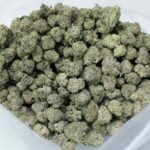 Macro photo of Violet Flame strain featuring vibrant purple hues and heavy resin, appealing to users wanting to buy top-tier indica hybrids in Canada.